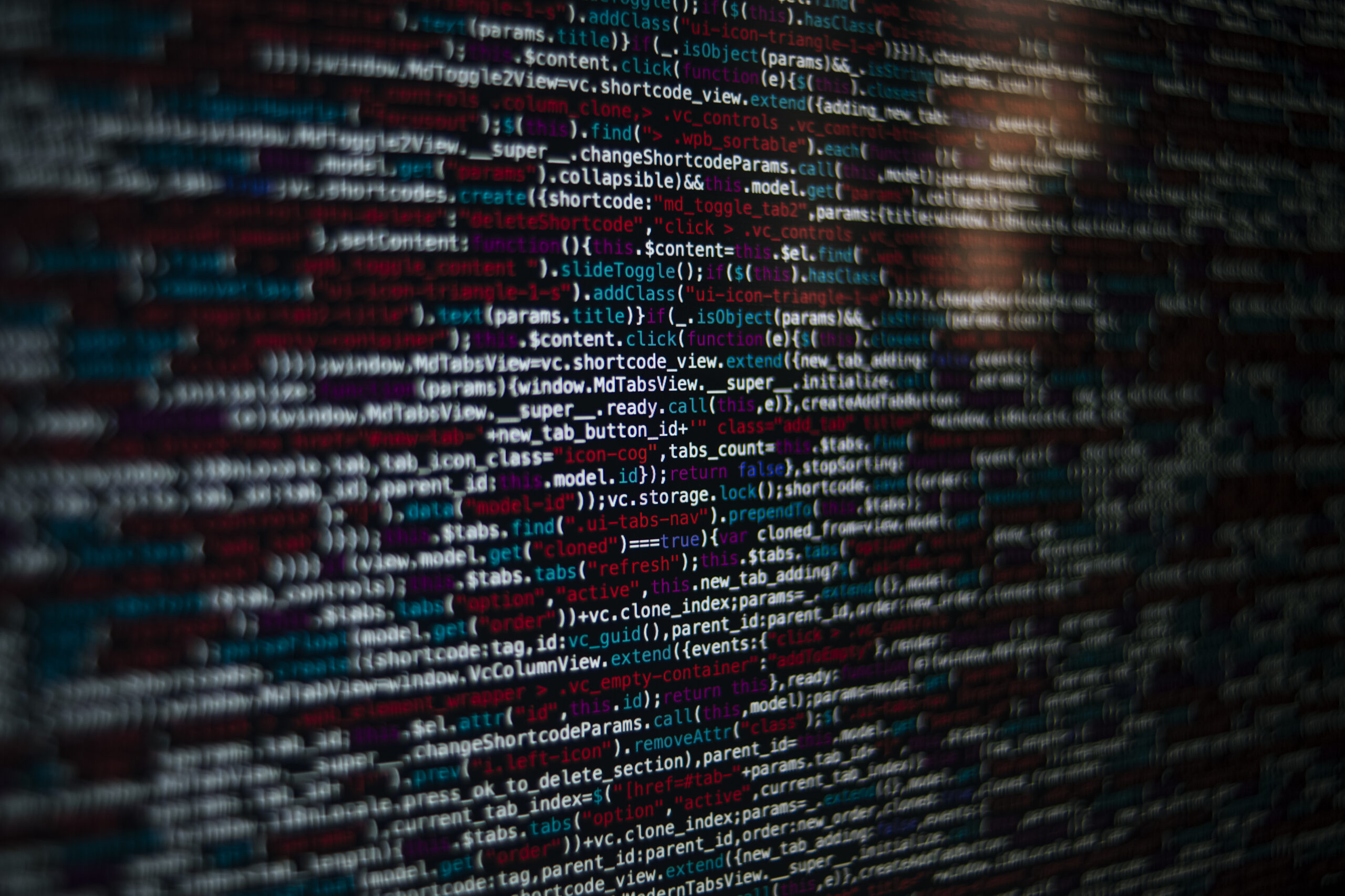A closeup shot of a screen with HTML JavaScript source code for web page development data