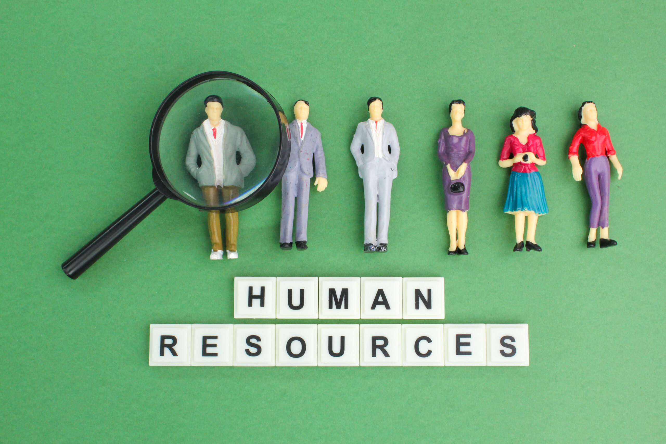 magnifying-glass-and-miniature-people-with-the-wor-2025-03-10-06-16-37-utc